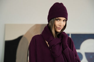 Frau in weinroter Mütze, Schal und Pullover